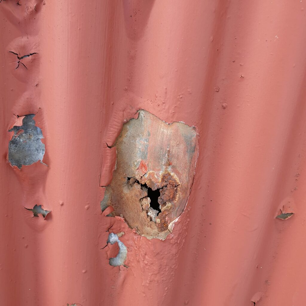Severe rust and holes in corrugated roof sheet found during Hobart roof inspection